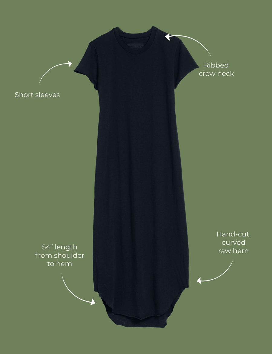 Lay flat image of the Harper dress. Arrows are pointing to different areas of the dress and text highlights features including short sleeves, ribbed crew neck, 54" length from shoulder to hem, hand-cut, curved raw hem. 